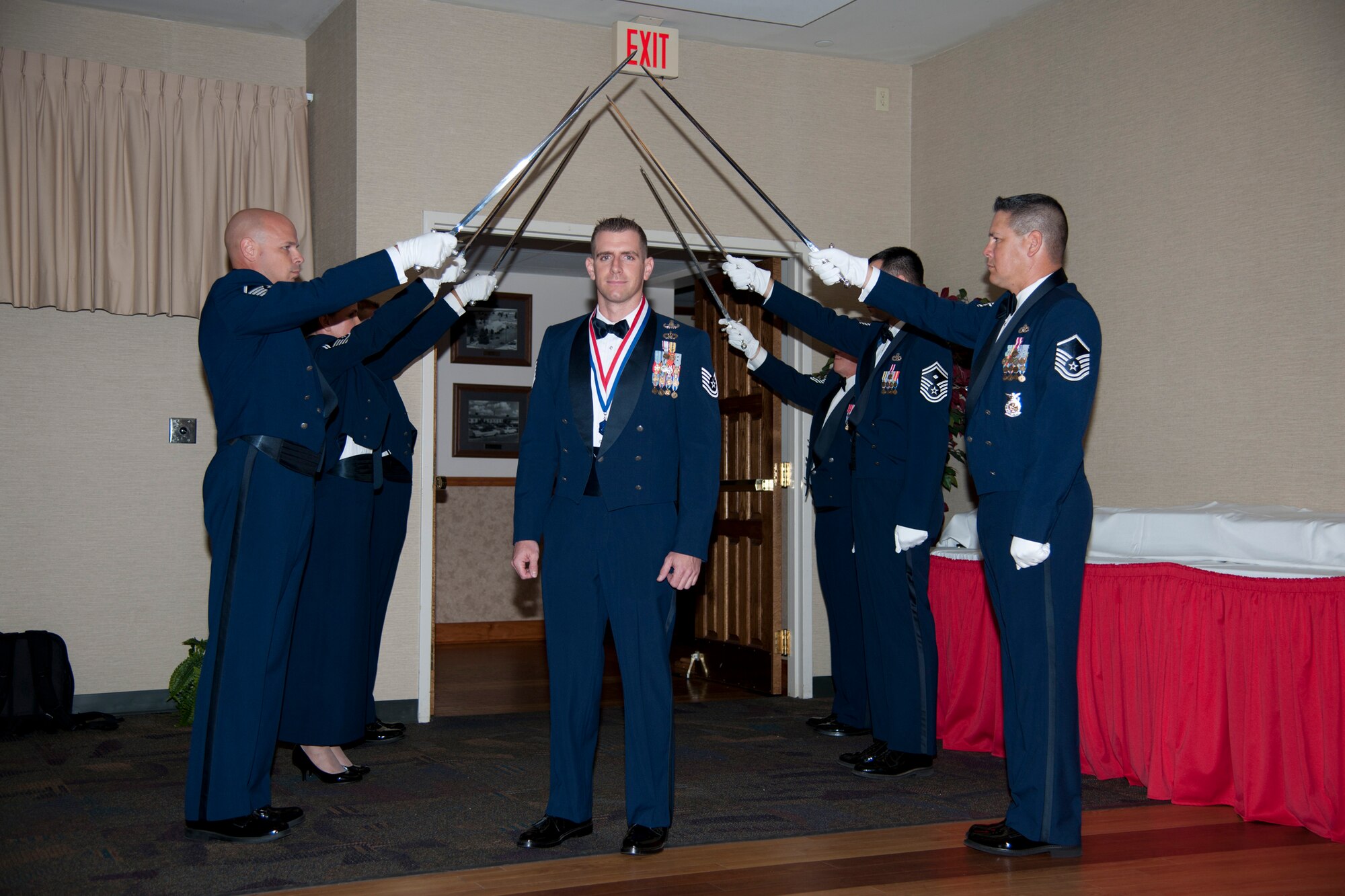 U.S. Air Force Tech. Sgt. Ryan Bobzin, 23d Civil Engineer Squadron, makes his way through a saber detail during a SNCO induction ceremony July 20, 2012, at Moody Air Force Base, Ga. Each member of the detail is a master sergeant or above and symbolizes the path from NCO to SNCO. (Airman 1st Class Paul Francis/Released)