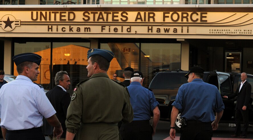 Col. Johnny Roscoe (left), 15th Wing commander, converses with Brig. Gen. Michael Hood, Rim of the Pacific military exercise Combined Forces Air Component Commander, following the arrival of the Right Honourable David Johnston, Governor General and Commander-in-Chief of Canada, at Joint Base Pearl Harbor-Hickam, Hawaii, for a visit during RIMPAC July 19. RIMPAC is the world's largest maritime military exercise. (U.S. Air Force photo by Capt. Ben Sakrisson)