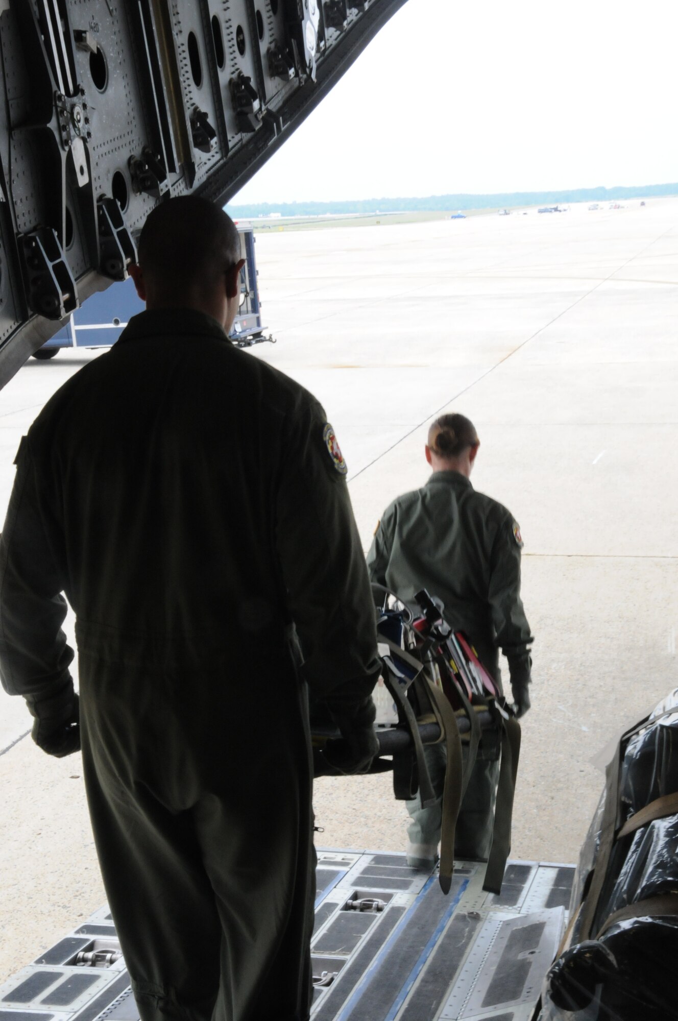 JOINT BASE ANDREWS, Md.,- Members from the 459th Aeromedical Evacuation Squadron here, off-load practice liters from a C-17 Globemaster III aircraft during a briefing to the Joint Civilian Orientation Conference on the process of an aeromedical evacuation, July 23, 2012. Participants of JCOC are guests of the Secretary of Defense and gain hands-on experience through operations and interactions with troops and military leaders stationed throughout the United States.  (U.S. Air Force photo/Senior Airman Katie Spencer)