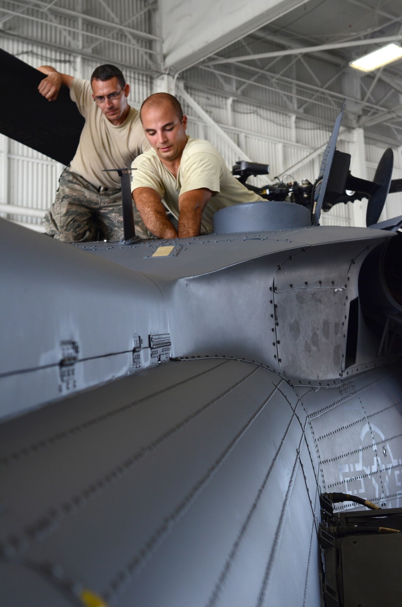 Staff Sgt. Lincoln Sinclair, HH-60G Pave Hawk helicopter crew chief, 920th Aircraft Maintenance Squadron, watches Senior Airman Nicholas Barbieri, also a HH-60 crew chief perform a torque check on a wing helicopter. The dual qualified 920th AMXS personnel are responsible for the operational readiness of both the HH-60 and the HC-130P/N King aircraft assigned to the 920th Rescue Wing, Patrick Air Force Base, Fla. Wing maintenance personnel perform scheduled inspections, functional checks and all preventive maintenance on all wing aircraft and aircraft installed equipment. (U.S. Air Force photo/Senior Airman Natasha Dowridge)
