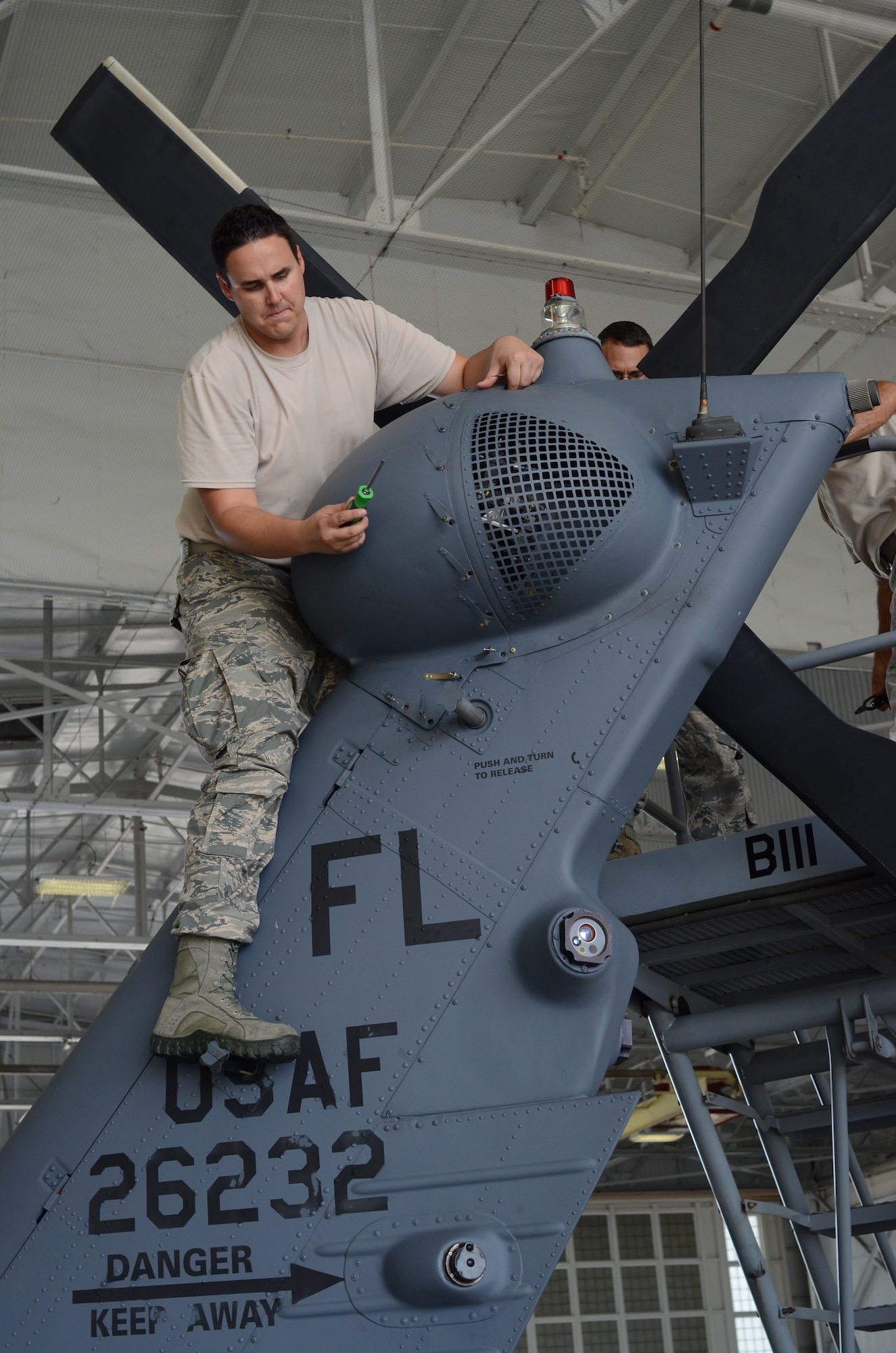 Tech. Sgt. Jared Kerns, HH-60G Pave Hawk helicopter crew chief, 920th aircraft maintenance squadron, puts a cowling over an HH-60 tail rotor after performing maintenance. The primary mission of the Pave Hawk helicopter is to conduct day or night personnel recovery operations into hostile environments to recover isolated personnel during war. Located at Patrick Air Force Base, Fla., the 920th Rescue Wing is the Air Force Reserve Command's premiere combat-search-and-rescue-unit. (U.S Air Force photo/Senior Airman Natasha Dowridge)