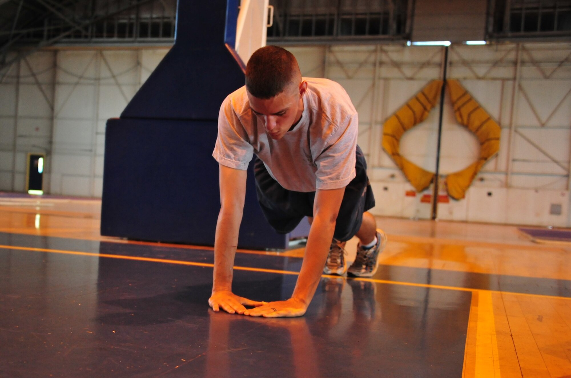 Senior Airman Christian Manning, Air University A4/6 Logistics and Programming computer programmer completes a set of diamond pushups at the Maxwell Gym Annex Wednesday. (U.S. Air Force photo by Senior Airman Christopher Stoltz)