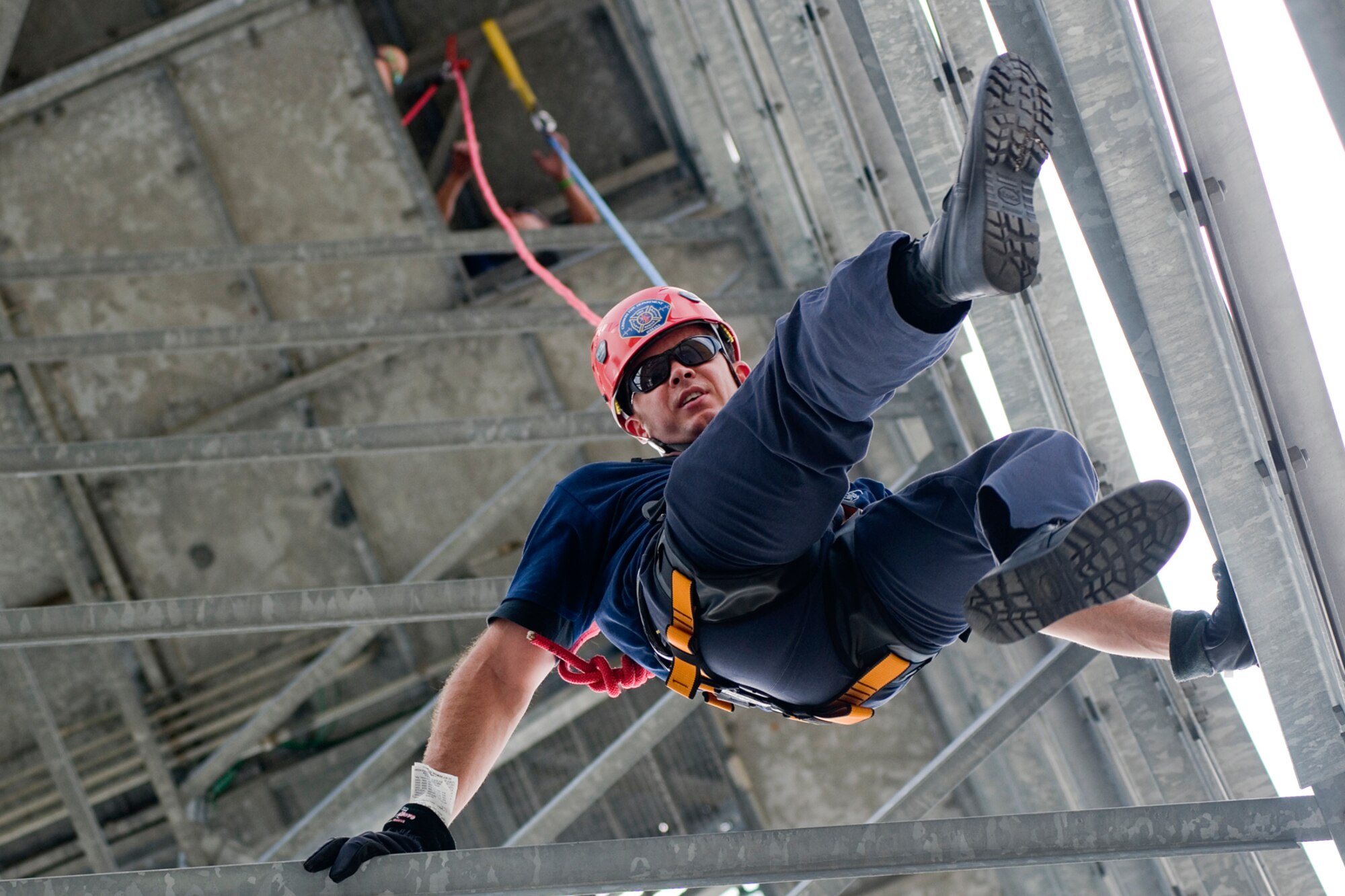 GRISSOM AIR RESERVE BASE, Ind. -- Robert Jacobs, Grissom firefighter, guides himself down the base radar tower as he rappels July 11. The Grissom Fire Department tested new harnesses used for rescue operations. (U.S. Air Force photo/Senior Airman Andrew McLaughlin)