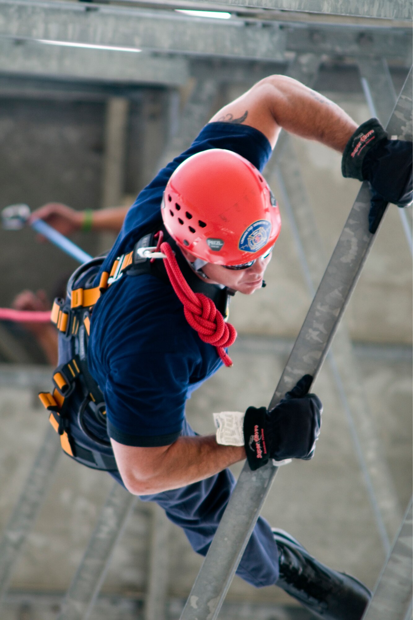 GRISSOM AIR RESERVE BASE, Ind. -- Robert Jacobs, Grissom firefighter, guides himself down the base radar tower as he rappels July 11. The Grissom Fire Department tested new harnesses used for rescue operations. (U.S. Air Force photo/Senior Airman Andrew McLaughlin)