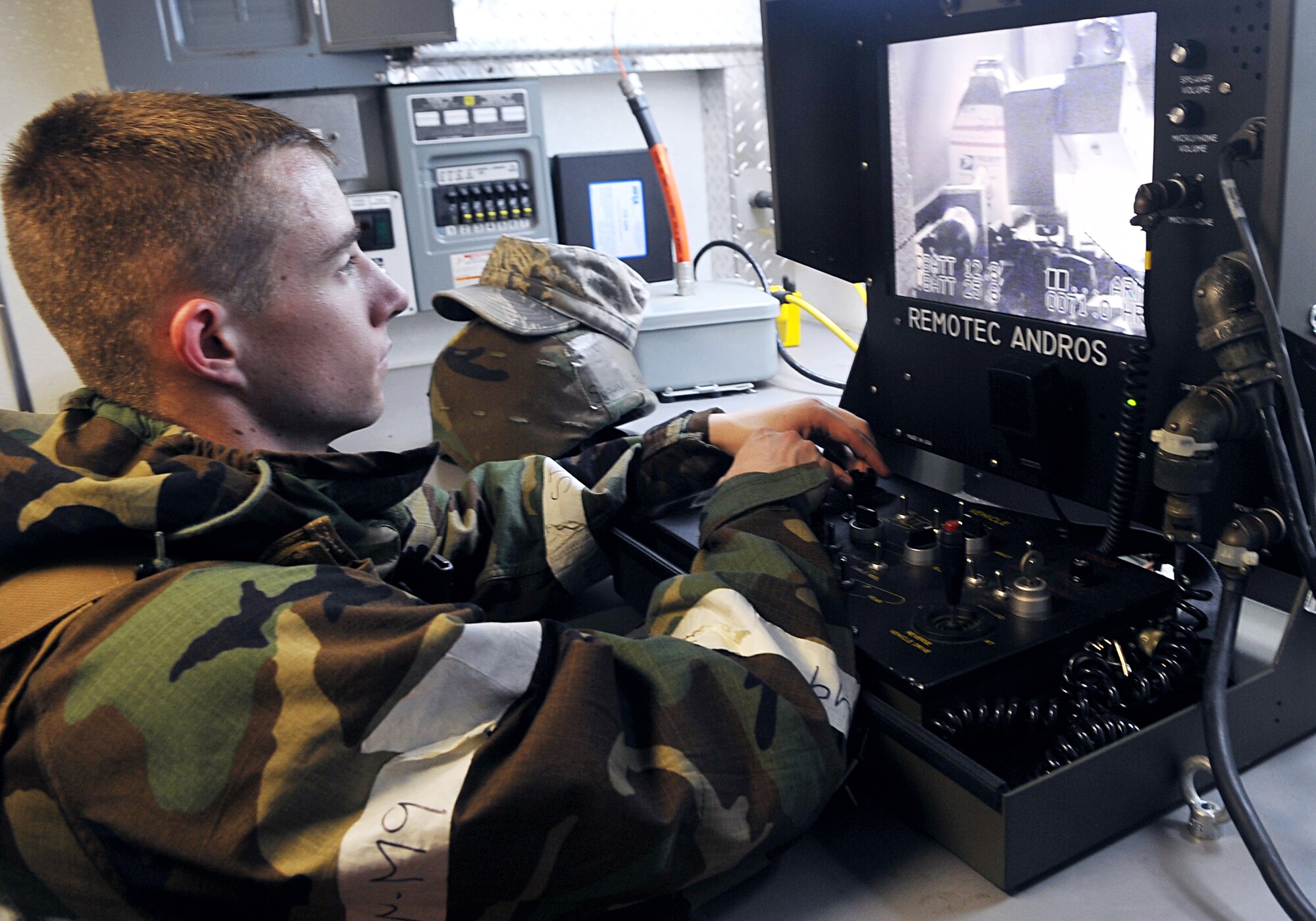 Airman 1st Class Shawn Hewitt takes the controls for an F6 robot used by the 51st Civil Engineer Squadron Explosive Ordinance Disposal team to get up close to possible hazardous materials present in a simulated suspicious package here, July 23, 2012. Osan Airmen are participating in exercise Beverly Midnight 12-03, which tests the base’s ability to operate in a heightened state of readiness. Hewitt is an EOD technician with the 51st CES. (U.S. Air Force photo/Staff Sgt. Stefanie Torres)