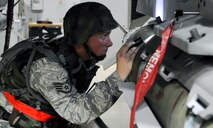 Staff Sgt. Brandon Smith inspects an F-16 Fighting Falcon after a weapons load during exercise Beverly Midnight 12-03, July 23, 2012. Smith is participating in Osan’s third readiness exercise in 2012. He is a 36th Aircraft Maintenance Unit weapons load crew member. (U.S. Air Force photo/Staff Sgt. Stefanie Torres)