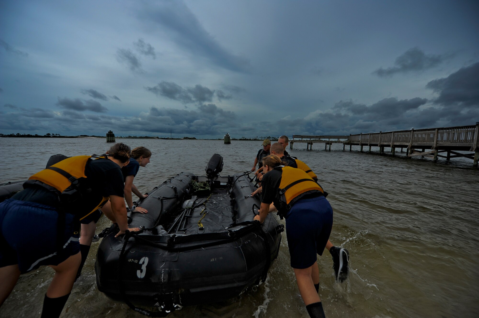Cadets from the Pensacola Air Force Junior ROTC push their boat into the water July 19, 2012 at the marina on Hurlburt Field, Fla. From July 16-20, more than 40 cadets from Pensacola Air Force Junior ROTC visited base for their Summer Leadership School -- a course designed to teach cadets leadership, confidence and other traits.(U.S. Air Force photo by Staff Sgt. David Salanitri/ Released)