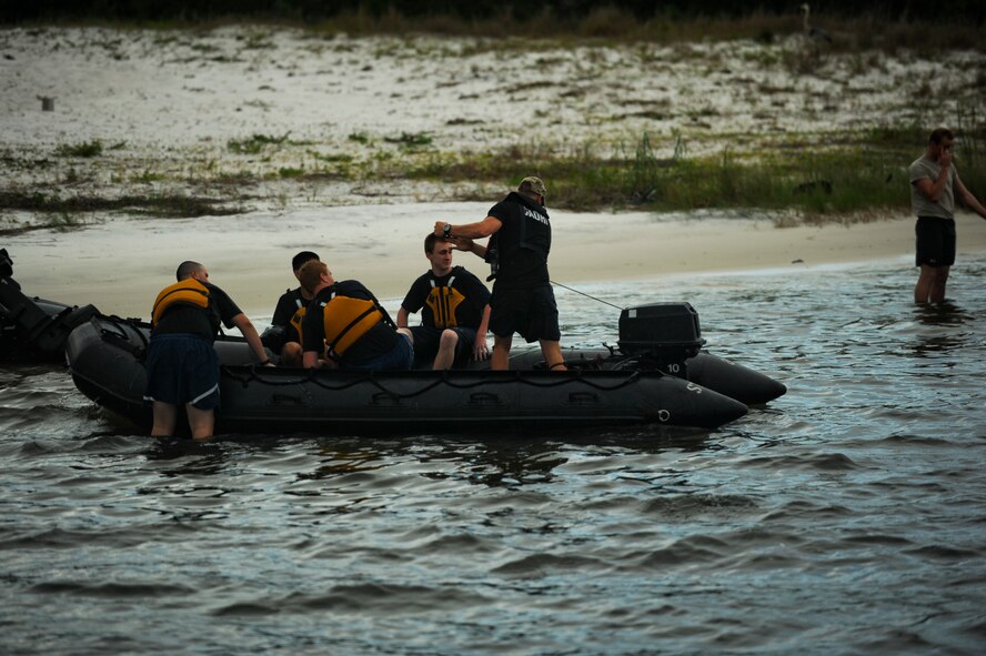 A cadre member from the Special Tactics Training Squadron starts a zodiac boat July 19, 2912, at the Hurlburt Field, Fla. marina. Cadre members took cadets from the Pensacola Air Force Junior ROTC out for a ride, getting to observe one of the ways special tactics Airmen arrive on the battlefield. (U.S. Air Force photo by Staff Sgt. David Salanitri/ Released)