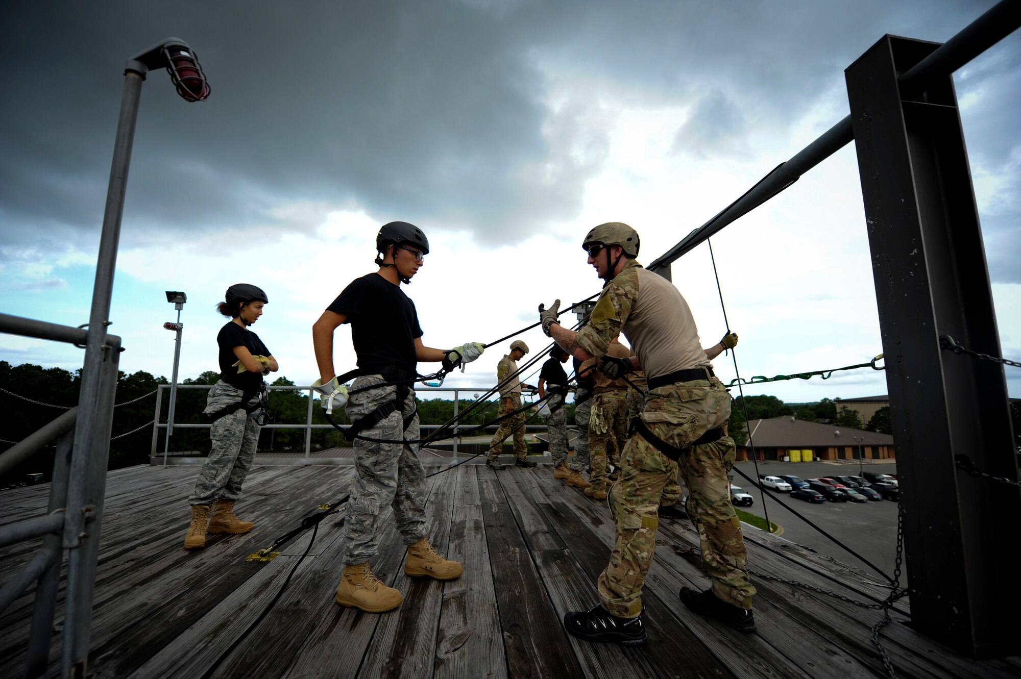 From right, Senior Airman Philip Armstrong, a pararescueman with the 23rd Special Tactics Squadron, coaches Cadet Kyle Bonsall, on how to rappel down the tower, July 18 at Hurlburt Field, Fla. From July 16-20, more than 40 cadets from Pensacola Air Force Junior ROTC visited base for their Summer Leadership School -- a course designed to teach cadets leadership, confidence and other traits.(U.S. Air Force photo by Staff Sgt. David Salanitri/ Released)