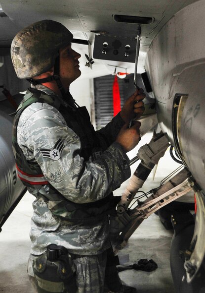 Senior Airman Andrew Anter tightens bolts on an F-16 Fighting Falcon during a weapons load July 23, 2012. Osan Airmen are participating in exercise Beverly Midnight 12-03, an exercise that tests Osan’s ability to continue the mission while at a heightened state of readiness. Anter is a 36th Aircraft Maintenance Unit weapons load crew member. (U.S. Air Force photo/Staff Sgt. Stefanie Torres)