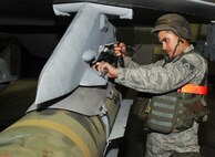 Senior Airman Jesus Lopez inspects weapons on an F-16 Fighting Falcon June 23, 2012. Aircrew Airmen worked through the night to prepare aircraft for combat readiness in Beverly Midnight 12-03, July 23, 2012. Lopez works with the 36th Aircraft Maintenance Unit as a weapons load crew member. (U.S. Air Force photo/Airman 1st Class Alexis Siekert)