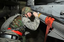 Staff Sgt. Brandon Smith inspects weapons on an F-16 Fighting Falcon here, June 23, 2012. Weapons load crew Airmen worked through the night to prepare aircraft for combat readiness in Beverly Midnight 12-03. Smith works with the 36th Aircraft Maintenance Unit as a weapons load crew member. (U.S. Air Force photo/Airman 1st Class Alexis Siekert)
