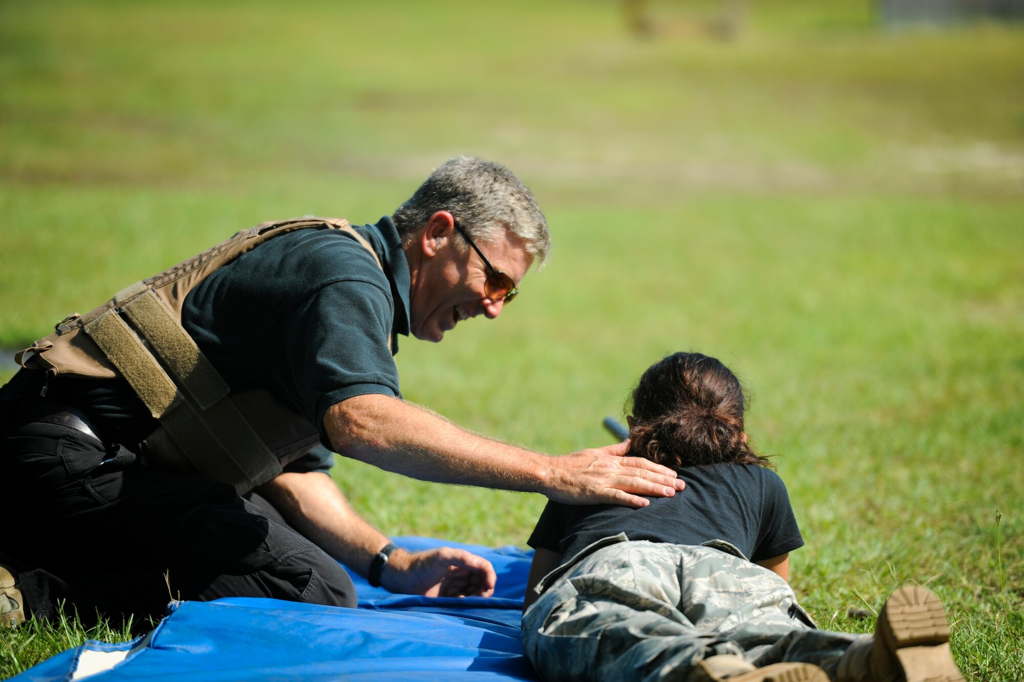 Chief Master Sgt. (ret) William Walter celebrates a 300 yard shot made by Pensacola Air Force Junior ROTC cadet Rosaly Tambini with a .50 cal. rifle, Jult 17, 2012 at Hurlburt Field, Fla. It was the first time Tambini fired a weapon. (U.S. Air Force photo by Staff Sgt. David Salanitri/ Released)