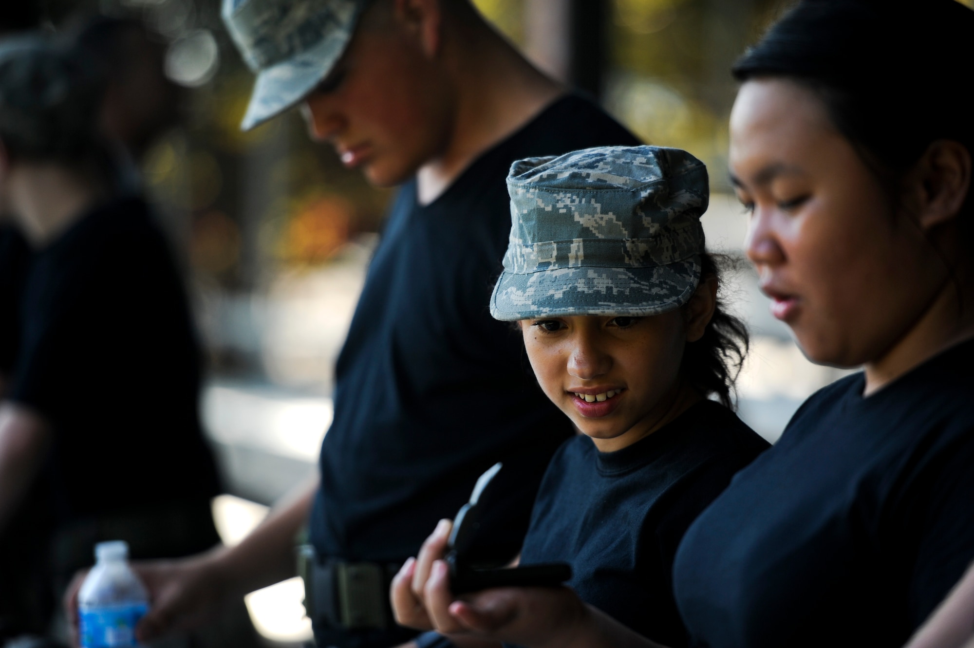 Pensacola Air Force Junior ROTC cadet, Rosaly Tambini holds up a cell phone, July 17, 2012 at Hurlburt Field, Fla. The cadets were shown items that could trigger bombs. (U.S. Air Force photo by Staff Sgt. David Salanitri/Released)