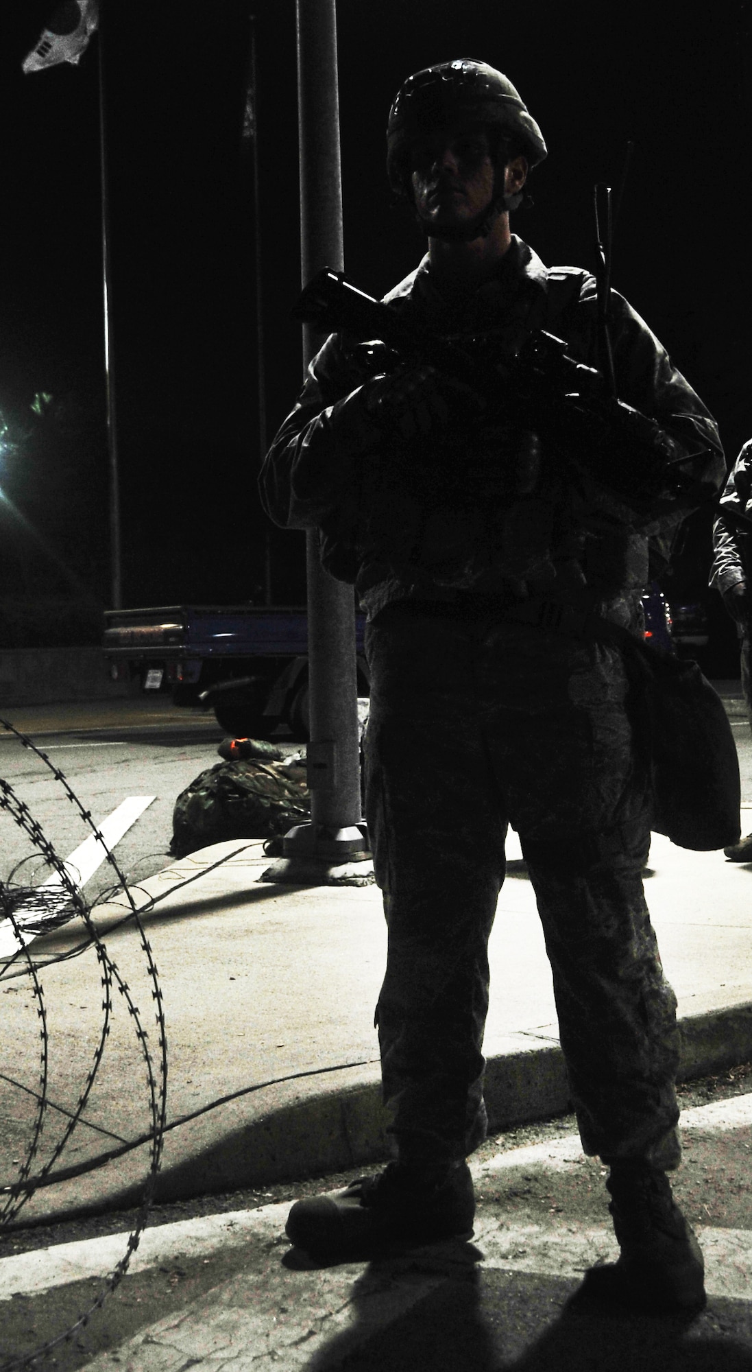 Airman 1st Class Isaac Saul IV guards an entry control point during exercise Beverly Midnight 12-03, July 22, 2012. BM 12-03 tests Team Osan’s ability to defend the base and conduct daily operations during a heightened state of readiness. Saul is a 51st Security Forces Squadron entry point controller. (U.S. Air Force photo/Staff Sgt. Stefanie Torres)