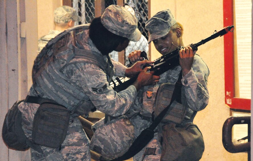 Osan Air Base's 51st Security Forces Squadron Airmen and base augmentees receive weapons from the armory July 22, 2012. Airmen reported following an exercise recall during Beverly Midnight 12-03. Airmen here are charged with defending Osan, execute combat operations, receive follow-on forces, and be ready to fight and win, tonight. (U.S. Air Force photo/Airman 1st Class Alexis Siekert)