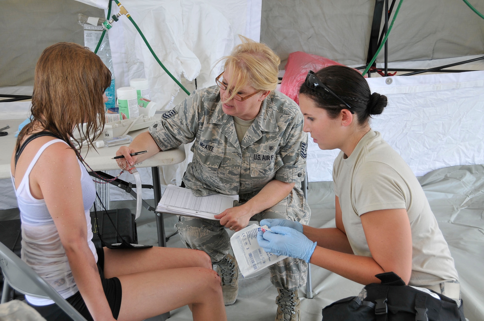 2nd Lt. Kelli Marietta and Tech. Sgt. Michael A. McAtee of the 181st Intelligence Wing/Medical Group/CERFP Element provide treatment to a wounded citizen during Patriot 2012 at Volk Field, Wis., July 18, 2012. (U.S. Air Force photo by Master Sgt. John Day/Released)