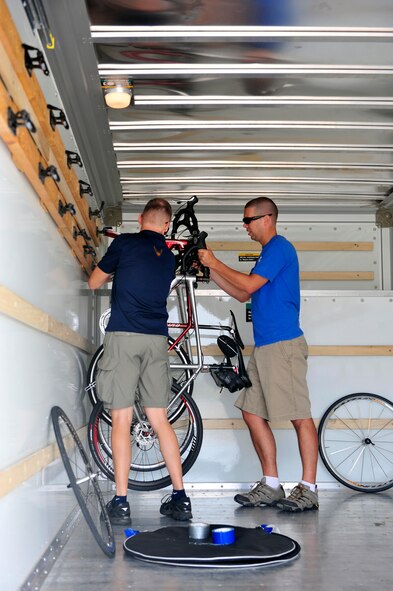 Capt. Rob Lounsbury and Maj. Jamie Cornett load bicycles and equipment into a trailer before driving to participate in the 40th Register’s Annual Great Bicycle Ride Across Iowa, July 22-28. RAGBRAI is the oldest, largest and longest bicycle touring event in the world. The truck will carry equipment for the whole trip. (U.S. Air Force photo/Staff Sgt. Stephenie Wade) 

