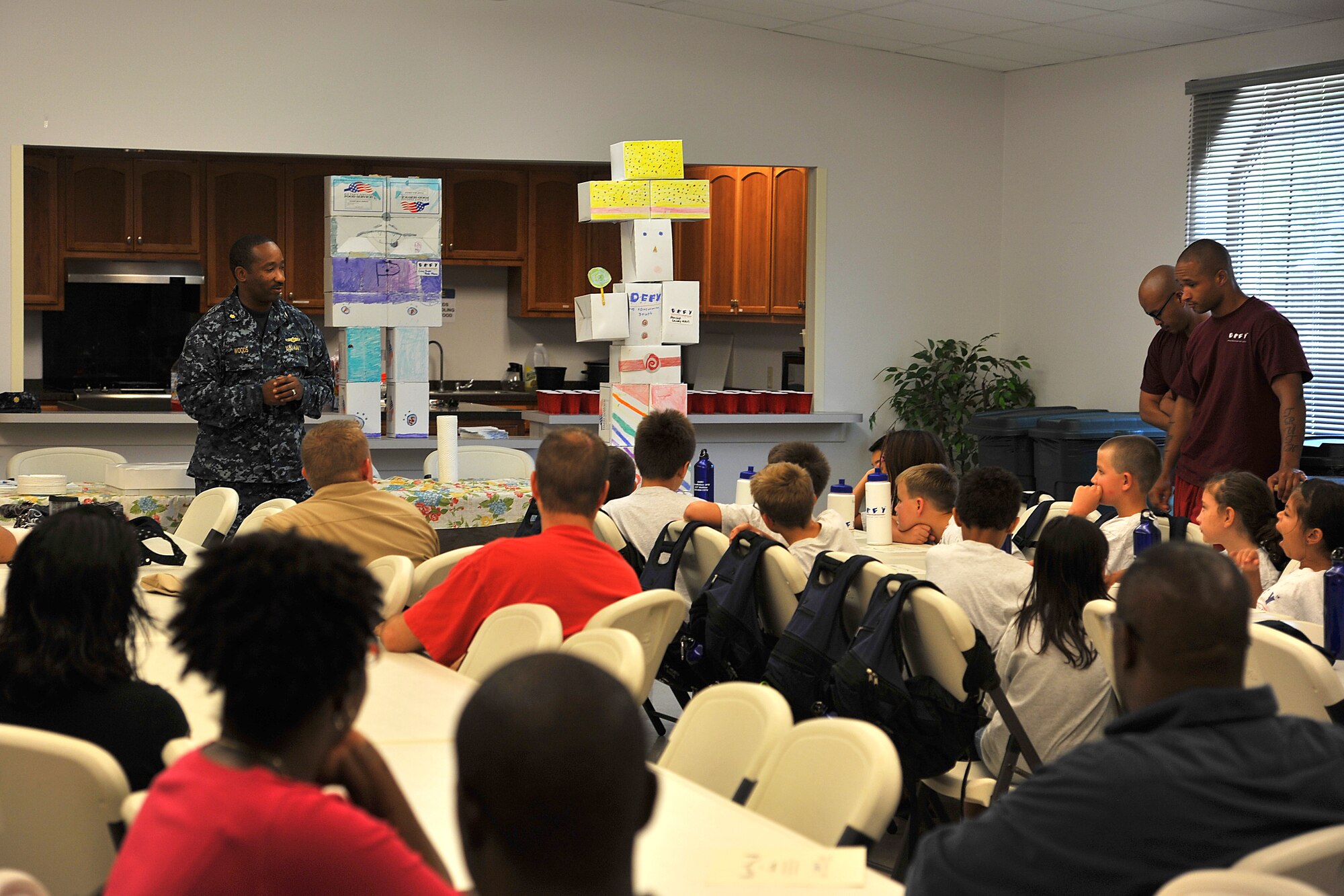 GOODFELLOW AIR FORCE BASE, Texas-- Lt. Cmdr. Cornell Woods, Center for Information Dominance Detachment Commander, congratulates the children of the Drug Education for Youth Camp on their hard work July 17. The DEFY camp helps teach children the potential dangers of drugs and ways they can affect your life. (U.S. Air Force photo/Airman 1st Class Michael Smith) 