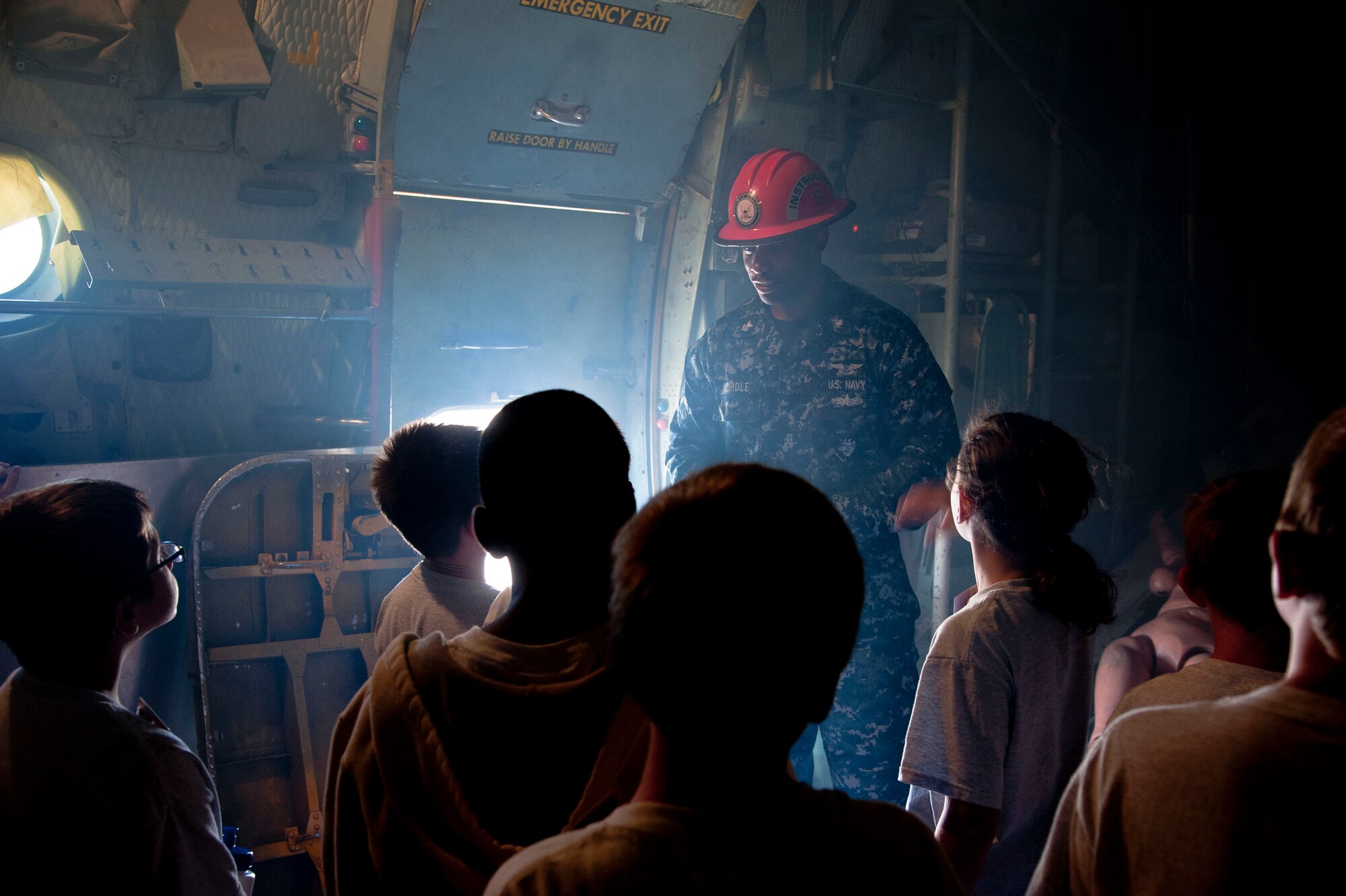 GOODFELLOW AIR FORCE BASE, Texas-- Petty Officer 1st Class Jerell Hurdle, 312th Training Squadron instructor, shows the children of the Drug Education for Youth Camp how difficult it can be to evacuate a smoky aircraft at Louis F. Garland DOD Fire Academy July 17. The DEFY camp helps teach children the potential dangers of drugs and ways they can affect your life. (U.S. Air Force photo/Airman 1st Class Michael Smith) 