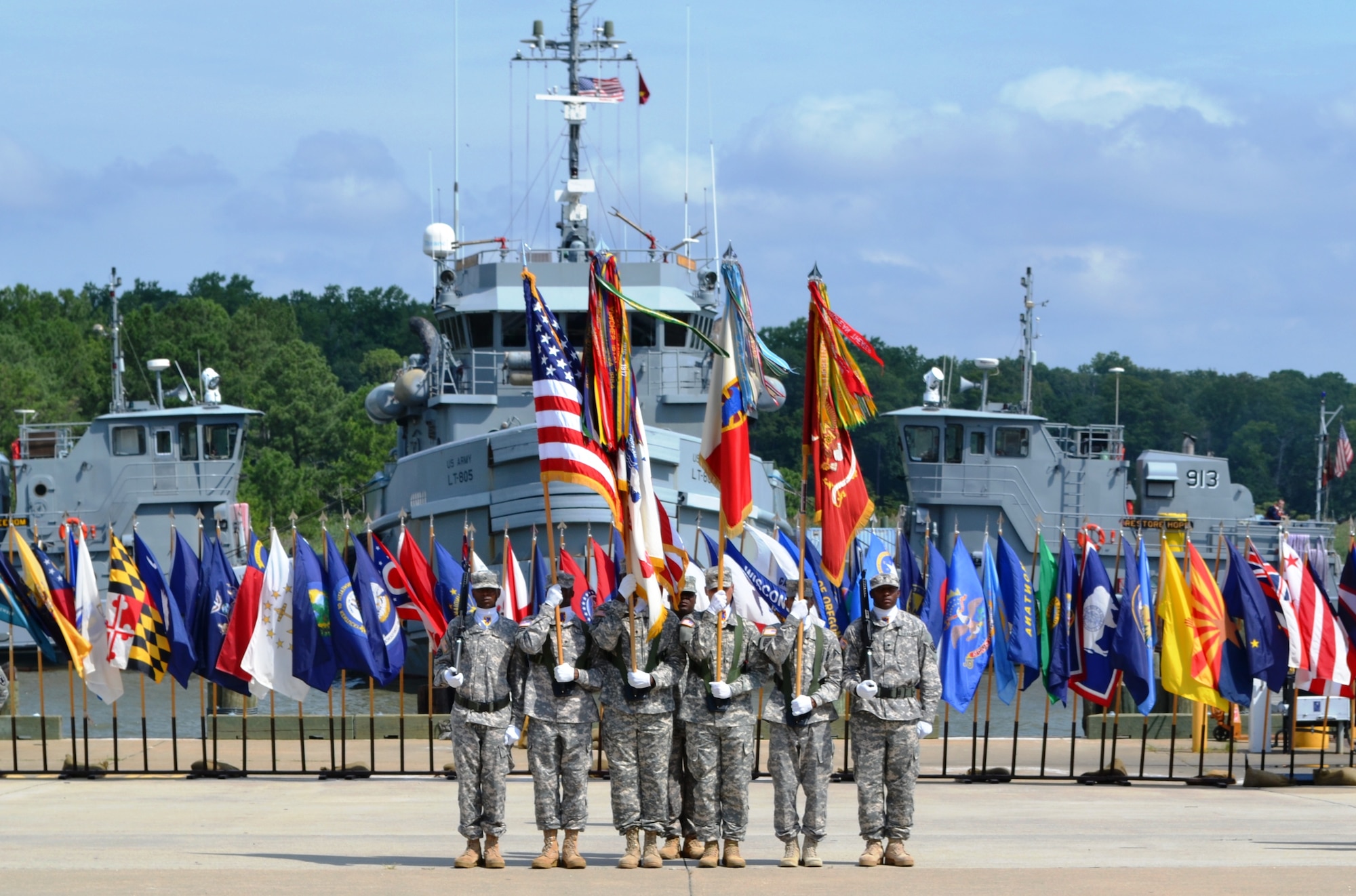 U. S. Army tugboats docked at 3rd Port on Fort Eustis, Va., render a water-canon salute during a change-of-command and change-of-responsibility ceremony, July 20, 2012. Lt. Col. Megan Gumpf took command, and Command Sgt. Maj. Scott Reed assumed responsibility of the 10th Trans. Bn. (U.S. Army photo by Staff Sgt. Alexander Burnett/Released)