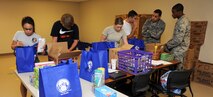 Volunteers assemble school supply bags to be given to Airmen E-5 and below July 19, 2012, McConnell Air Force Base, Kan. The bags will be given out during the Free School Supply Giveaway and Information Fair taking place July 23 through July 27, 2012. (U.S. Air Force photo/Airman 1st Class Jose L. Leon)