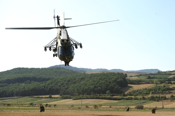 A Romanian IAR 330 helicopter flies above Romanian air force special forces members during a combat search and rescue training exercise with the 81st Fighter Squadron in a field here July 19, 2012, during Dacian Thunder. (U.S. Air Force photo by Senior Airman Natasha Stannard)