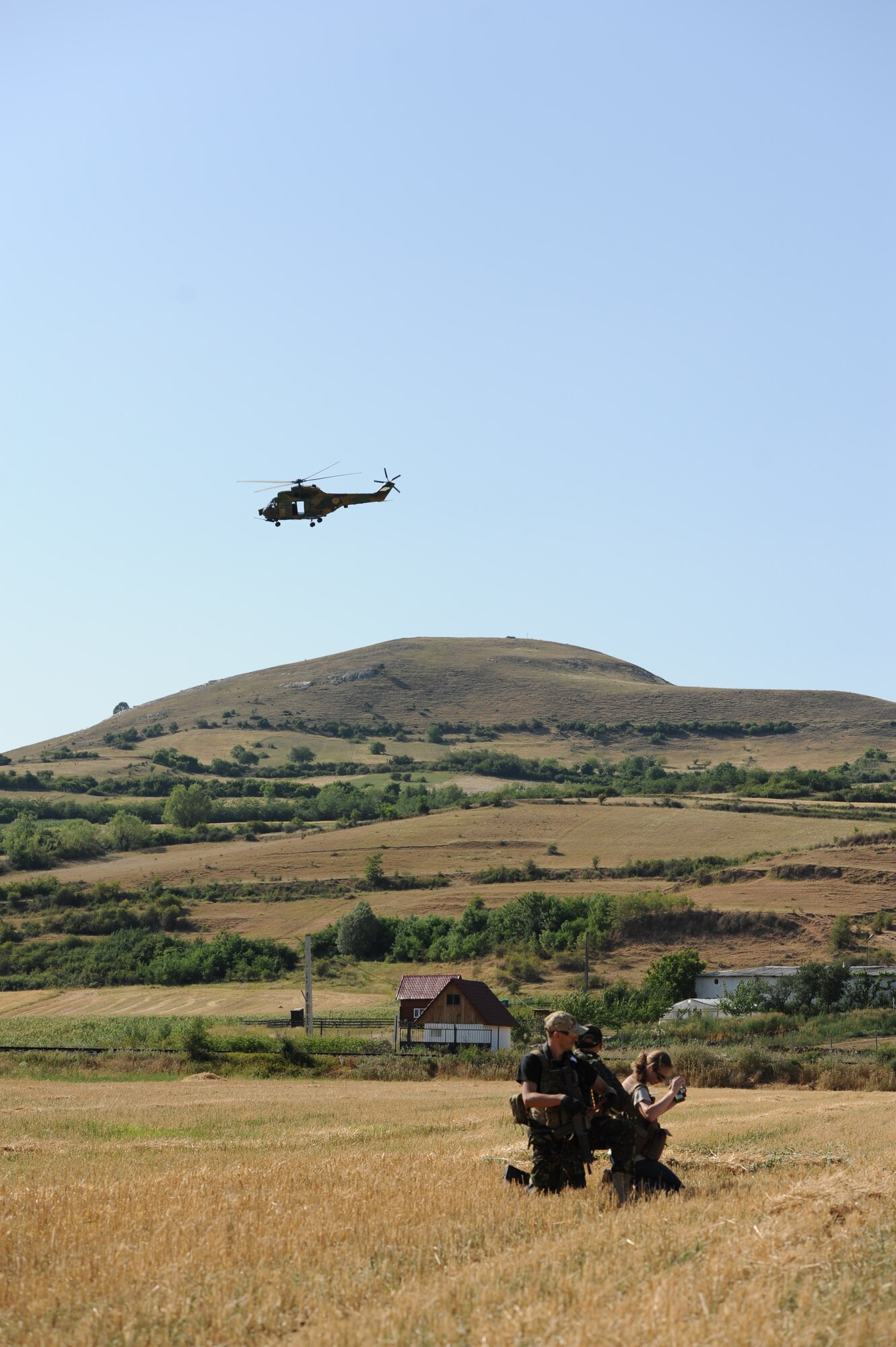 CAMPIA TURZII, Romania – A Romanian IAR 330 helicopter flies above as Capt. Maureen Hartney, 81st Fighter Squadron executive officer, is rescued by Romanian air force special forces members during a combat search and rescue training exercise in a field here July 19. This CSAR exercise was a part of Dacian Thunder, a month-long partnership building exercise in which U.S. Air Force, Romanian air force, U.S. Marine Corps and the Royal Air Force exchange techniques, tactics, and procedures to strengthen coalition and joint capabilities. (U.S. Air force photo by Senior Airman Natasha Stannard/Released)