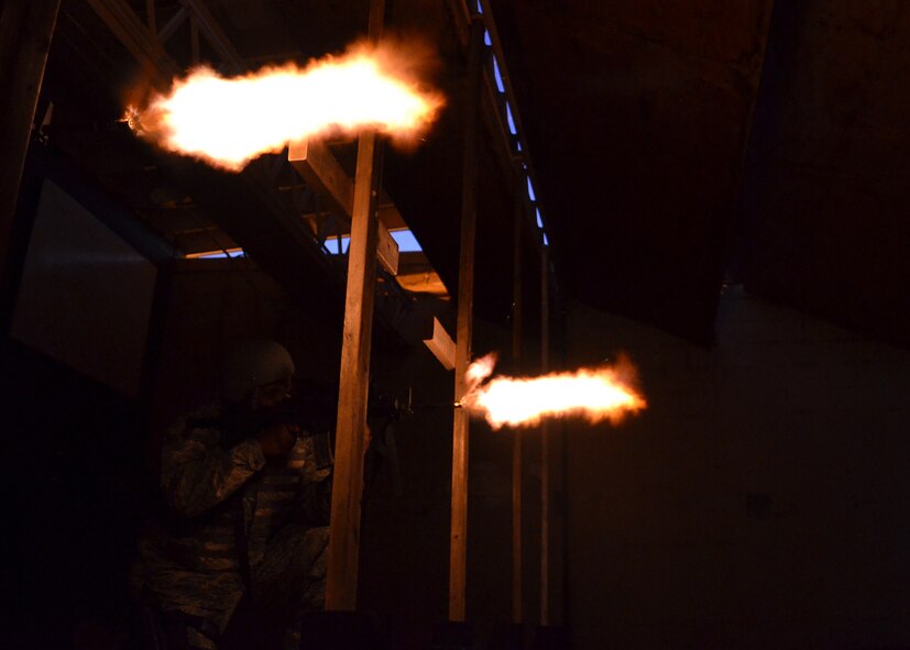 Airmen from the 7th Security Forces Squadron fire M-4 Carbines during night-fire training July 19, 2012 at Dyess Air Force Base, Texas. Airmen fired 70 rounds from an M-4 Carbine mounted with a PVS-14 in front of a red dot sight. The scope collects small amounts of light and amplifies it, allowing the shooter to see down range in low-light situations. The targets were 25 feet away, but distances are simulated between 70 and 300 meters. (U.S. Air Force photo by Airman 1st Class Damon Kasberg/Released)