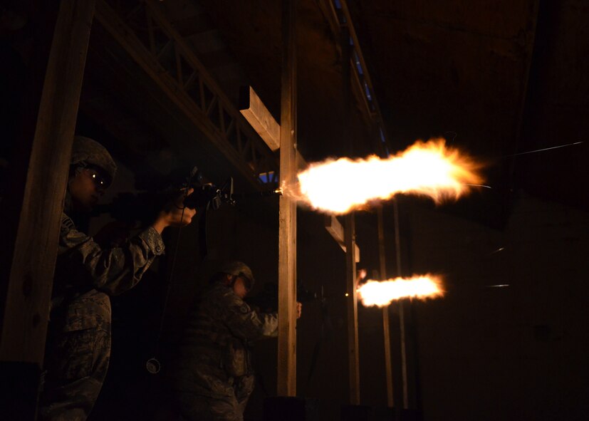 Airmen from the 7th Security Forces Squadron fire M-4 Carbines during night-fire training July 19, 2012 at Dyess Air Force Base, Texas. Airmen fired 70 rounds from an M-4 Carbine mounted with a PVS-14 in front of a red dot sight. The scope collects small amounts of light and amplifies it, allowing the shooter to see down range in low-light situations. The targets were 25 feet away, but distances are simulated between 70 and 300 meters. (U.S. Air Force photo by Airman 1st Class Damon Kasberg/Released)