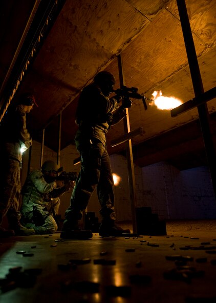 Airmen from the 7th Security Forces Squadron fire M-4 Carbines during night-fire training July 19, 2012 at Dyess Air Force Base, Texas. Airmen fired 70 rounds from an M-4 Carbine mounted with a PVS-14 in front of a red dot sight. The scope collects small amounts of light and amplifies it, allowing the shooter to see down range in low-light situations. The targets were 25 feet away, but distances are simulated between 70 and 300 meters. (U.S. Air Force photo by Airman 1st Class Damon Kasberg/Released)