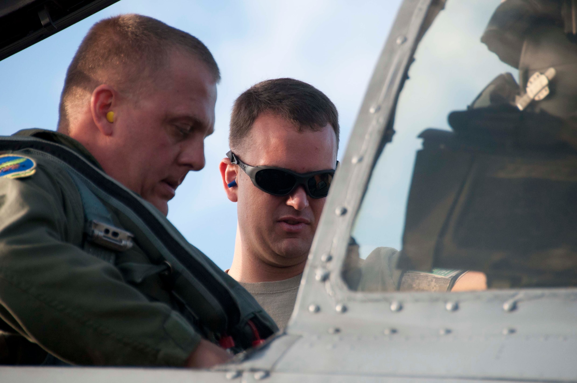 U.S Air Force Staff Sgt. Justin Browning, 917th Maintenance Squadron crew chief, works with U.S. Air Force Maj. Maury Kent, 47th Fighter Squadron, prior to a sortie during Rim of the Pacific exercise at Joint Base Pearl Harbor-Hickam, Hawaii, July 17,2012. Twenty-two nations, more than 40 ships and submarines, more than 200 aircraft and 25,000 personnel are participating in RIMPAC exercise from June 29 to Aug. 3, in and around the Hawaiian Islands. The world's largest international maritime exercise, RIMPAC provides a unique training opportunity that helps participants foster and sustain the cooperative relationships that are critical to ensuring the safety of sea lanes and security on the world's oceans. RIMPAC 2012 is the 23rd exercise in the series that began in 1971. (U.S. Air Force photo by Staff Sgt. Ted Daigle)