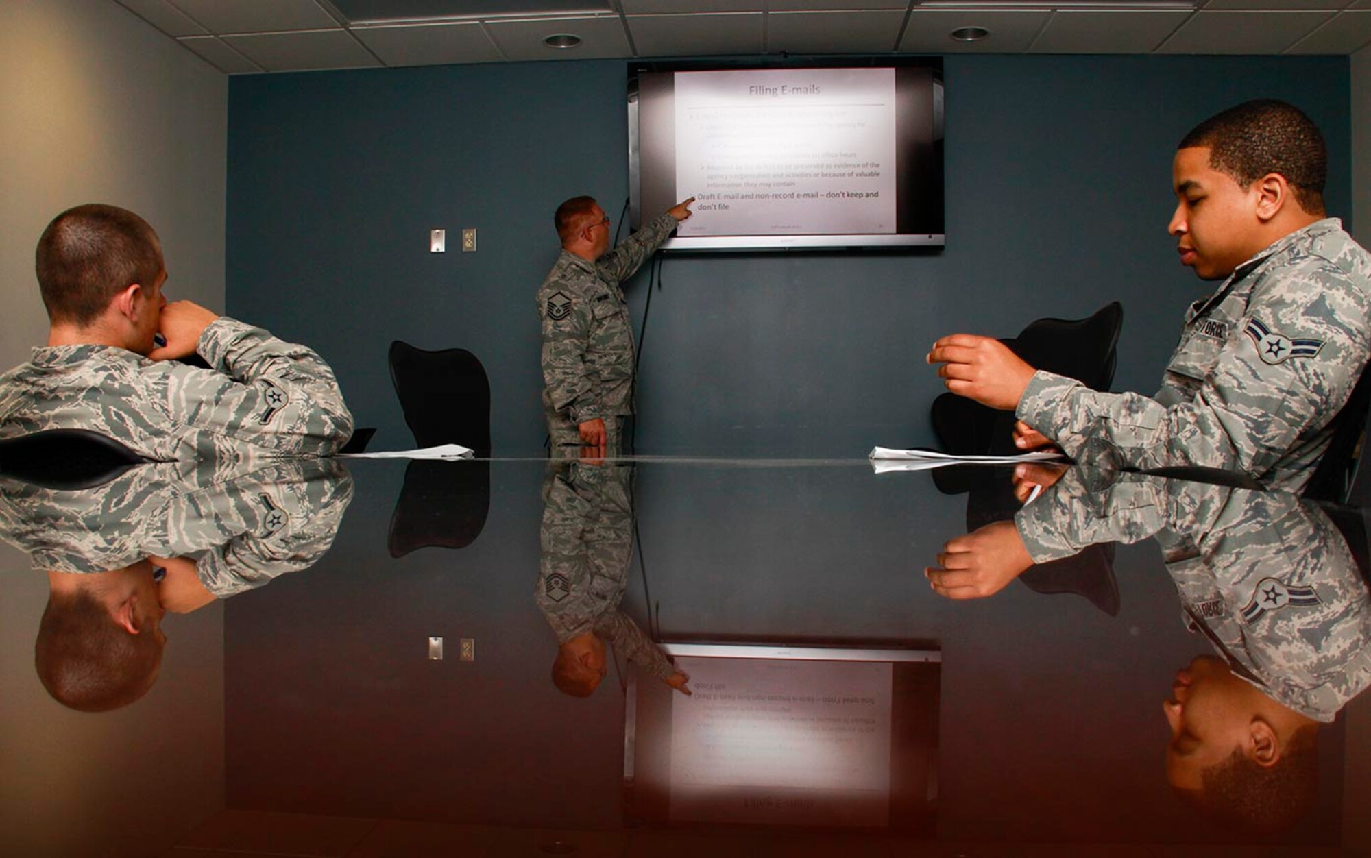 Master Sgt. Doug Obeldobel, functional area manager for the 911th Airlift Wing Knowledge Operations Management, explains record management to two journeymen, Airman Jon Novak (left) from the Operations Squadron and Airman 1st Class Quayshawn Hallenback from the Civil Engineering Squadron, here, July 19, 2012. Obeldobel instructs the Seasonal Training Program at the base which totals 90 days. The length of STP depends on the nature of the career field with some needing only a month and others up to a year to receive the necessary job training. (U.S. Air Force photo by Senior Airman Justyne Obeldobel/Released)