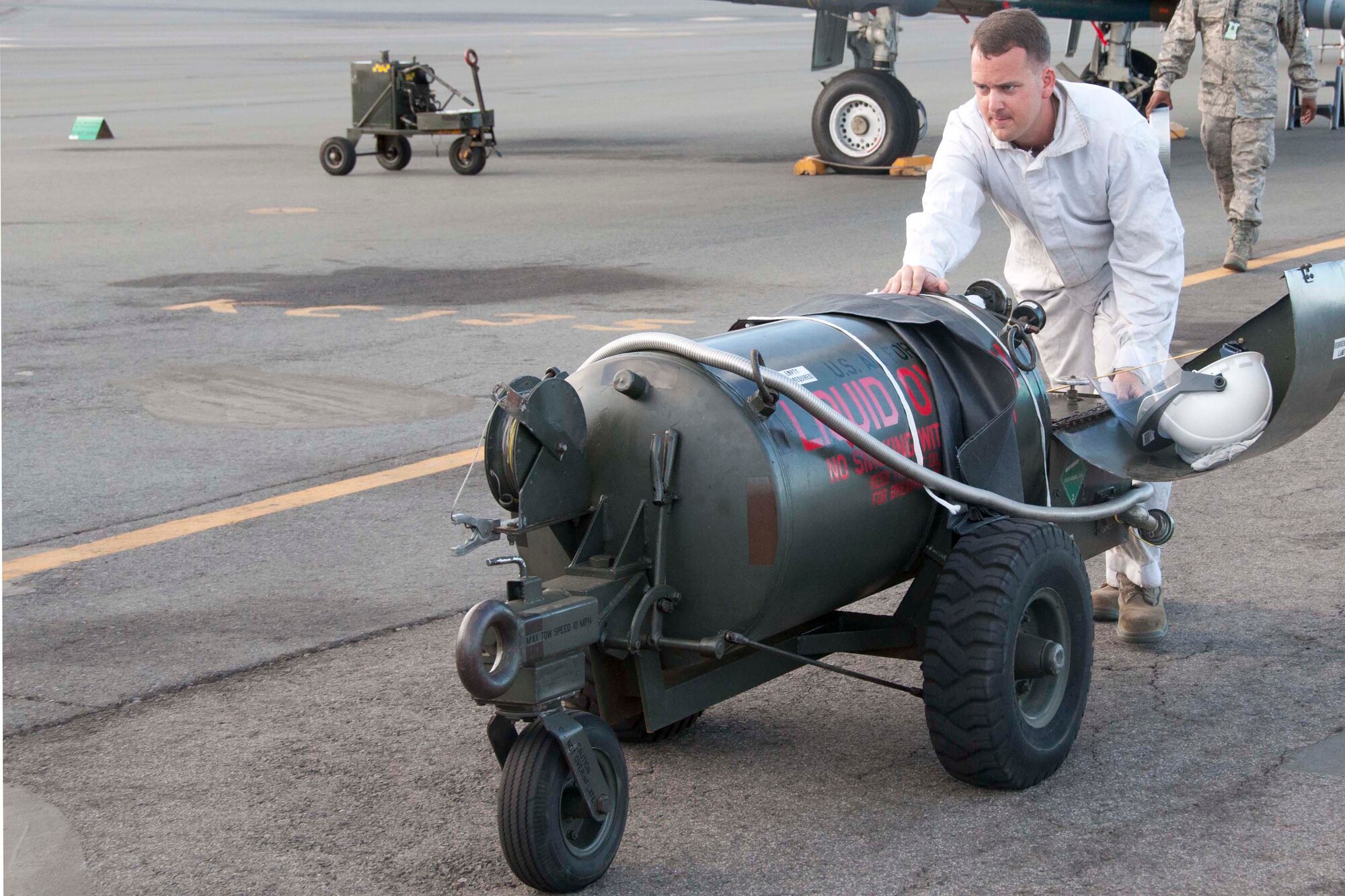 U.S. Air Force Staff Sgt. Justin Browning, 917th Maintenance Squadron crew chief, pushes a tank of liquid oxygen to a waiting A-10 Thunderbolt II in preparation for a sortie during the Rim of the Pacific  military exercise at Joint Base Pearl Harbor-Hickam, Hawaii, July 17, 2012.  Twenty-two nations, more than 40 ships and submarines, more than 200 aircraft and 25,000 personnel are participating in RIMPAC exercise from June 29 to Aug. 3, in and around the Hawaiian Islands. The world's largest international maritime exercise, RIMPAC provides a unique training opportunity that helps participants foster and sustain the cooperative relationships that are critical to ensuring the safety of sea lanes and security on the world's oceans. RIMPAC 2012 is the 23rd exercise in the series that began in 1971.(U.S. Air Force photo by Staff Sgt. Ted Daigle/ Released)