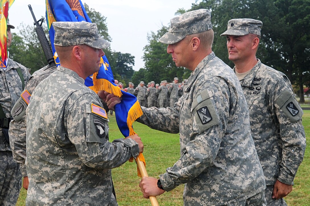 U.S. Army Col. Dean D. Heitkamp, U.S. Army Aviation Logistics School commander, passes the guidon to Lt. Col. Michael R. Williams, incoming 1st Battalion, 222nd Aviation Regiment commander, at the change-of-command ceremony at Fort Eustis, Va., July 20, 2012. Traditionally, passing the guidon from one commander to another represents the passing of trust and well being of the unit. (U.S. Air Force photo by Staff Sgt. Ashley Hawkins/Released)