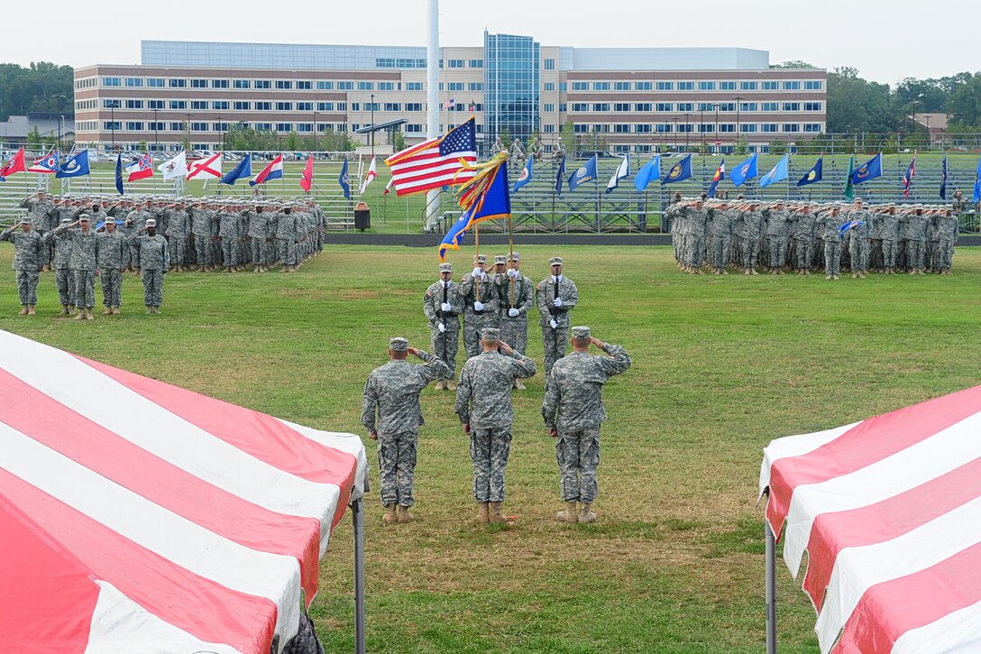 The 1st Battalion, 222nd Aviation Regiment, renders a salute to the U.S. flag during the playing of the National Anthem, during the change-of-command ceremony at Fort Eustis, Va., July 20, 2012. The ceremony was held to honor the incoming commander, U.S. Army Lt. Col. Michael R. Williams, as well as give a final farewell to the outgoing commander, Lt. Col. James E. Huber. (U.S. Air Force photo by Staff Sgt. Ashley Hawkins/Released)