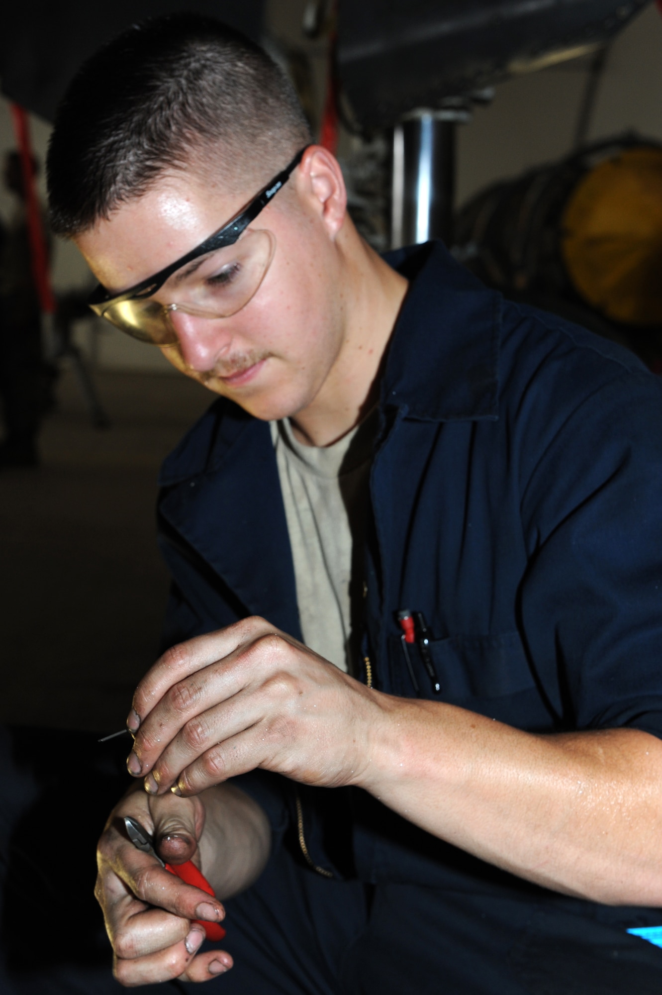 SOUTHWEST ASIA - U.S. Air Force Airman 1st Class Christopher Keays, 380th Expeditionary Maintenance Squadron phase inspection team member, inspects a cotter pin July 20, 2012. Keays, a Catasauqua, Pa., native, is deployed from Mountain Home Air Force Base, Idaho. (U.S. Air Force photo/Master Sgt. Scott MacKay)
