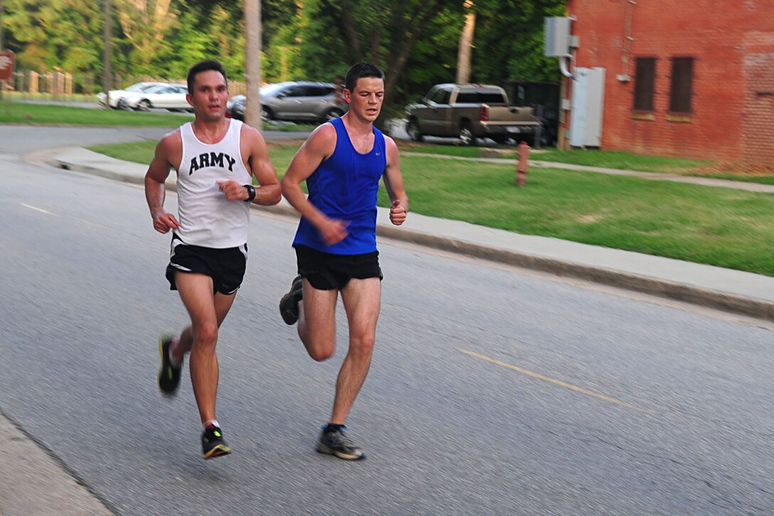 U.S. Army 2nd Lts. Bryce Livingston, left, and Blaine O’Reilly, both with the 149th Transportation Battalion, finish 1st and 2nd, with a time of 30:26, during the Army Ten-Miler time trial at Fort Eustis, Va., July 20, 2012. The trial consisted of a 5.5-mile run, which led to the selection of eight members who will represent Fort Eustis at the national Army Ten-Miler in October, in Washington, D.C. (U.S. Air Force photo by Staff Sgt. Ashley Hawkins/Released)