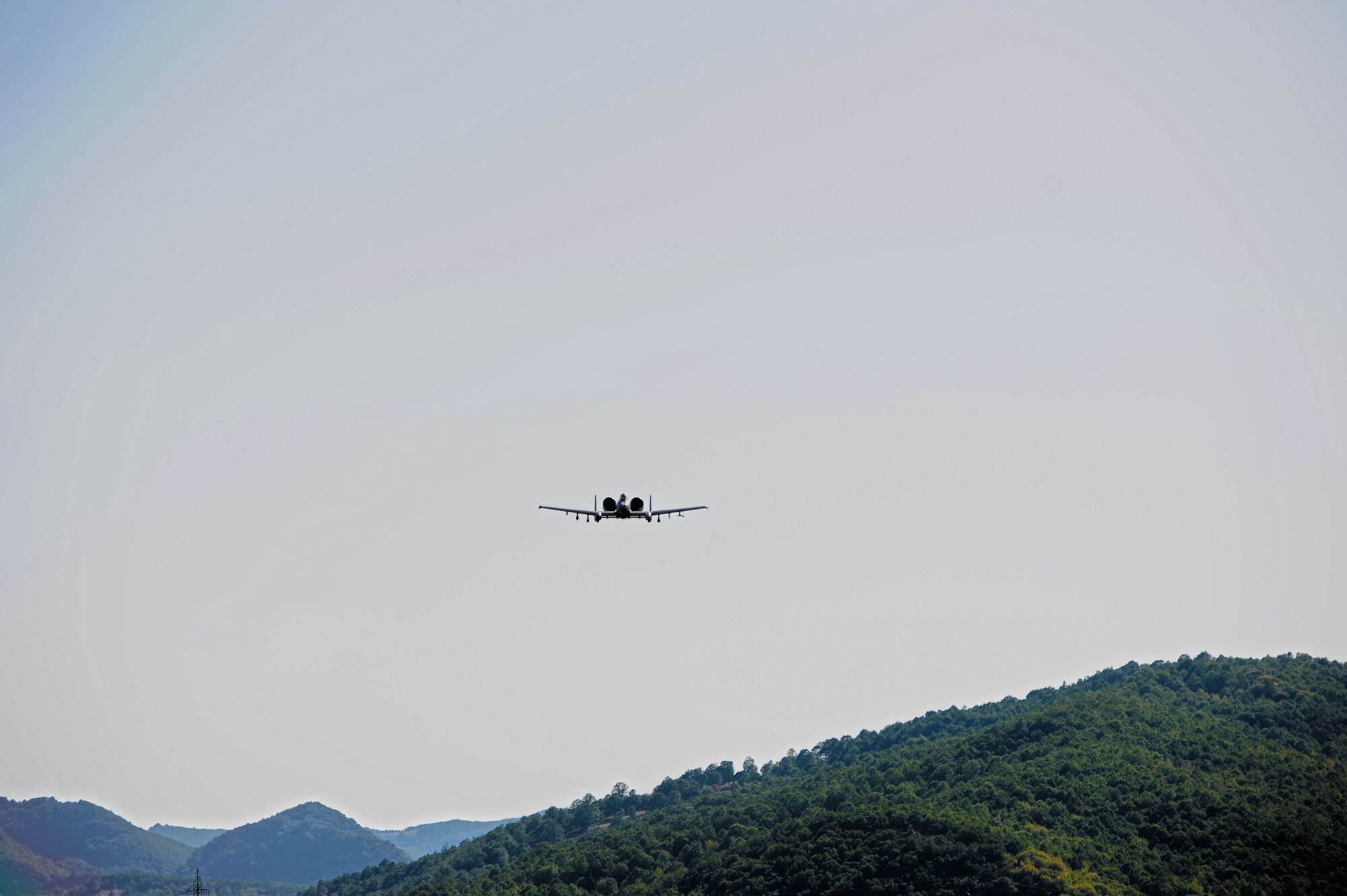 CAMPIA TURZII, Romania -- An 81st Fighter Squadron A-10 Thunderbolt II flies above a field as it supports two Romanian IAR 330 helicopters to and from a combat search and rescue training mission July 19 during Dacian Thunder here. The A-10 pilots worked with IAR helicopter pilots to locate and safely rescue a survivor in this mission.  Dacian Thunder is a month-long partnership building exercise in which the U.S. Air Force, Romanian air force, U.S. Marine Corps and the Royal Air Force exchange techniques, tactics and procedures to strengthen coalition and joint capabilities. (U.S. Air force photo by Senior Airman Natasha Stannard/Released)