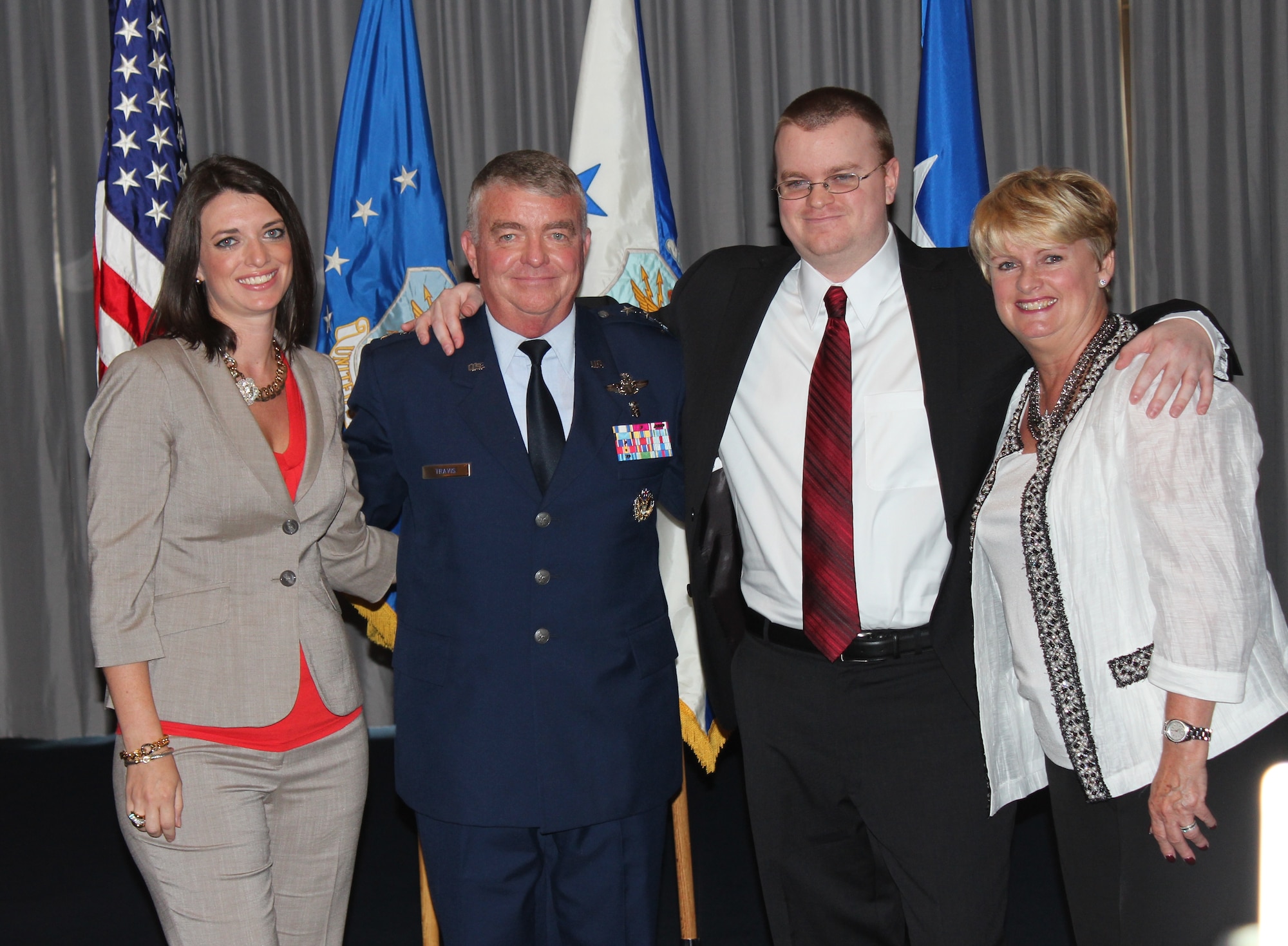 Lt. Gen. (Dr.) Thomas W. Travis, Air Force Surgeon General, stands with his family during his promotion ceremony on July 20 at the Bolling Club. (Photo by Jon Stock, U.S. Air Force)