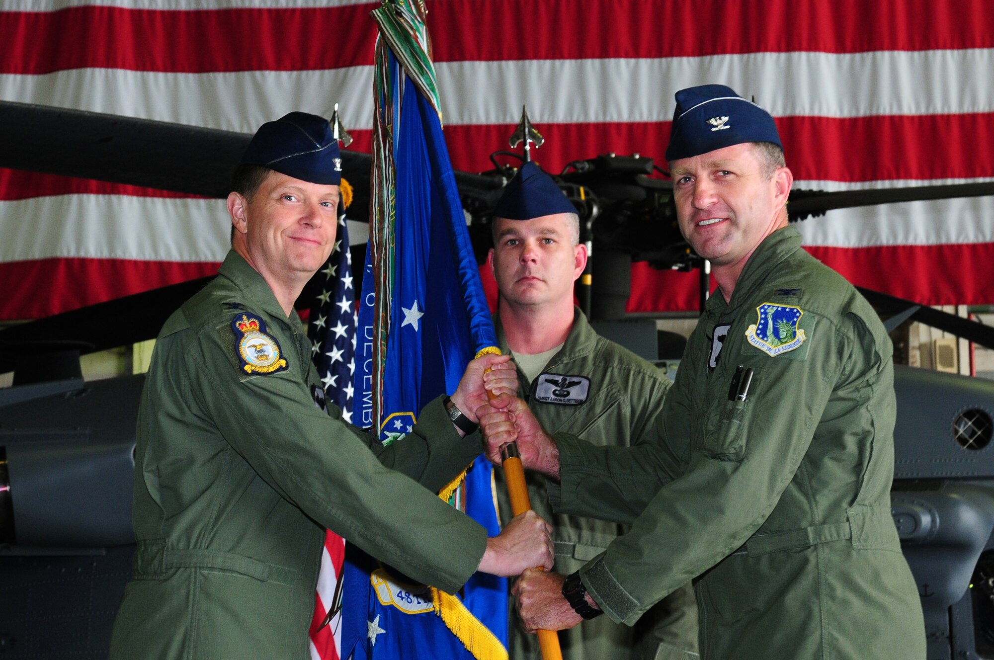 ROYAL AIR FORCE LAKENHEATH, England – Col. Kyle Robinson, 48th Fighter Wing commander, passes the guidon to Col. Mark Slocum, 48th Operations Group commander, during the 48th OG Assumption of Command ceremony July 20, 2012. Slocum assumed command of the 48th OG, which was formerly commanded by Col. Daniel Orcutt. (U.S. Air Force photo by Airman 1st Class Cory Payne)