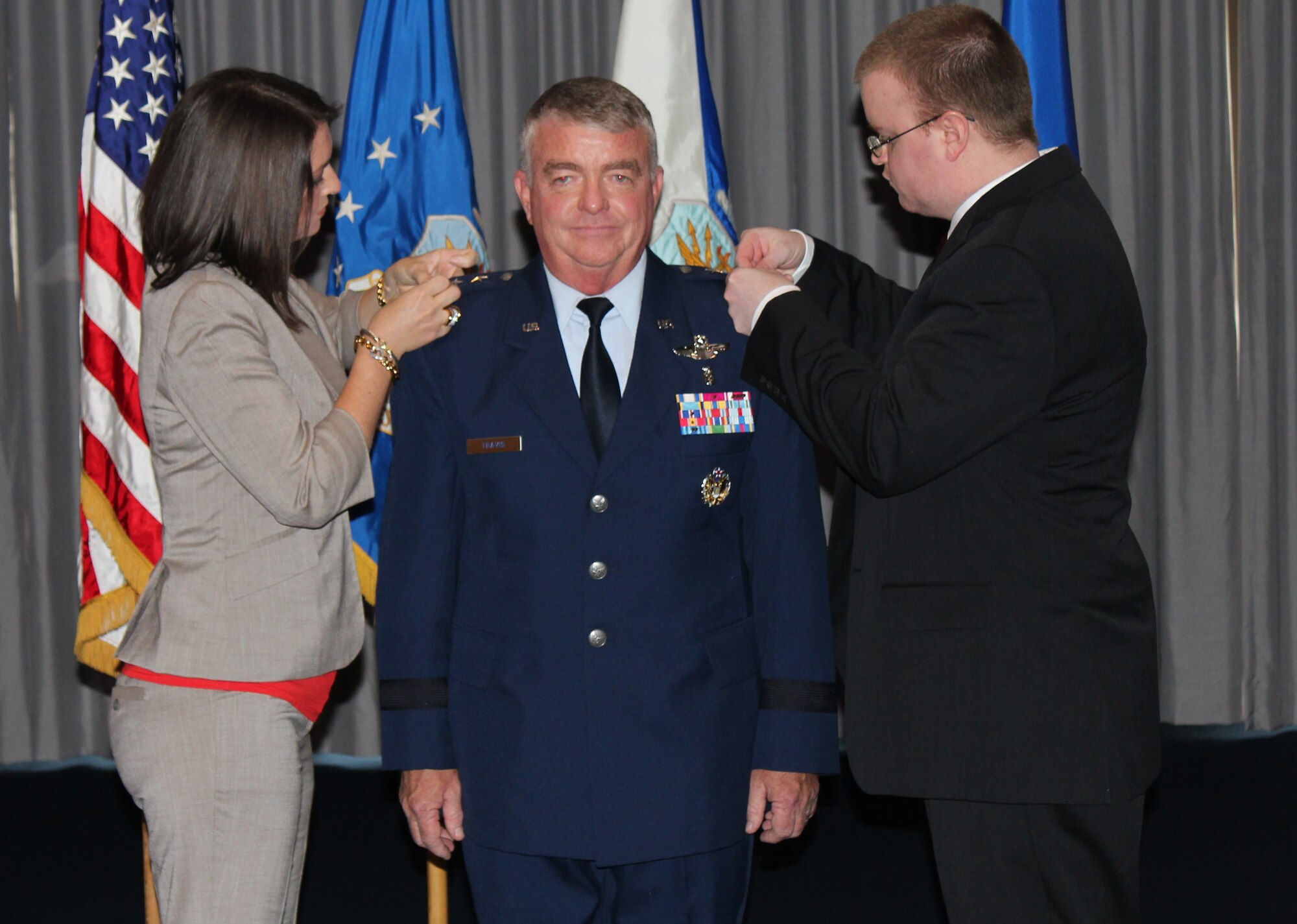 Lt. Gen. (Dr.) Thomas W. Travis, Air Force Surgeon General, has his children pin the 3rd star on during a ceremony on July 20 at the Bolling Club. (Photo by Jon Stock, U.S. Air Force)