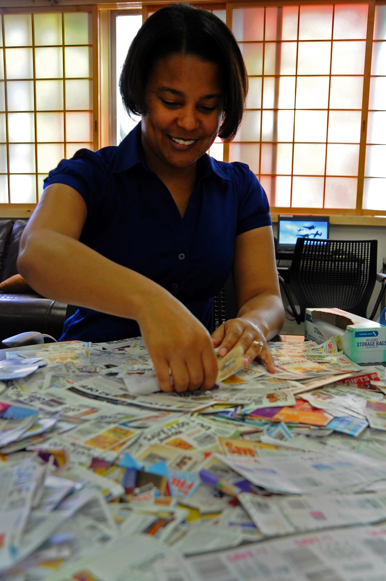 Ashlei Collins, 35th Force Support Squadron volunteer, checks expiration dates on coupons donated by veteran’s organizations, July 23, 2012 at Misawa Air Base, Japan. The Airman and Family Readiness Center has many financial classes and lots of information available to all members of the base community.  (U.S. Air Force photo by Staff Sgt. April Quintanilla)
