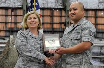 Col. Deborah Meserve, former 51st Maintenance Group commander, presents, Tech. Sgt. James Calzo, 51st Maintenance Squadron avionics production supervisor, the Air Force’s 2011 Outstanding Electronic Warfare Officer Award. Calzo sustained Pacific Air Forces largest electronic attack pod inventory that enabled Osan to fly more than 5,000 sorties. Calzo, a native of San Diego, Calif., is on his third duty assignment at Osan Air Base, and he is currently on a three-year tour. (U.S. Air Force photo/Staff Sgt. Craig Cisek)