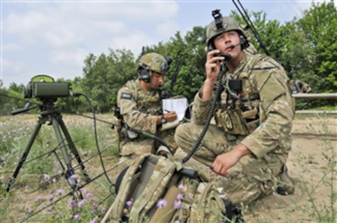 Staff Sgt. Alejandro Saldivar (left) and Senior Airman Rob Designe communicate with the pilots of A-10 Thunderbolt aircraft on a close air support mission during Exercise Northern Strike 2012 at Grayling Air Gunnery Range, Mich., on July 18, 2012. Saldivar and Designe are attached to the 168th Air Support Operations Squadron, Peoria, Ill.  