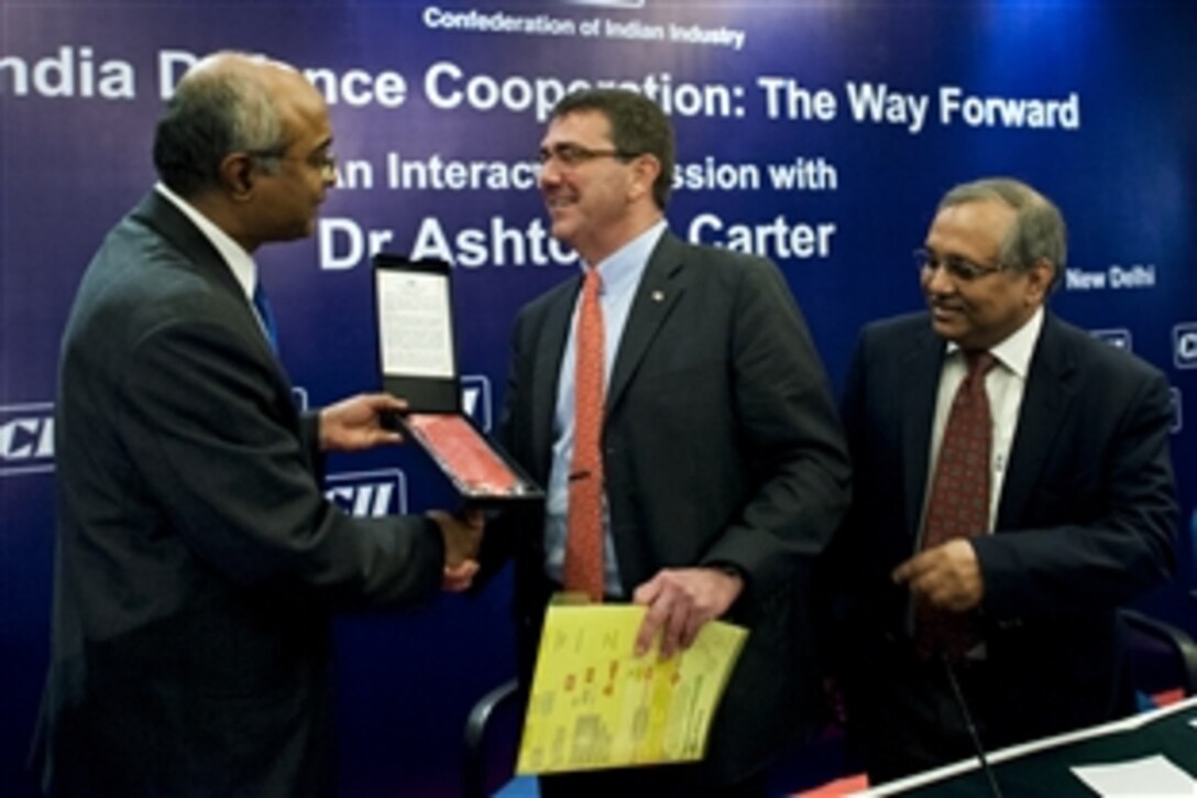 V. Sumantran, left, chairman of the Confederation of Indian Industry’s national defense council, and Chandrajit Banerjee, right, director general of the Confederation of Indian Industry, thank U.S.  Deputy Defense Secretary Ashton B. Carter, center, following his speech addressing U.S.-India relations in New Delhi, July 23, 2012. Carter is on a 10-day Asia Pacific trip to meet partners in Hawaii, Guam, Japan, Thailand, India and South Korea. 