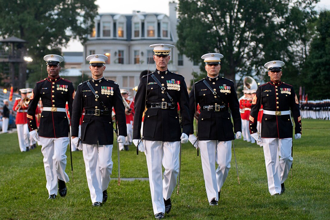 The parade staff marches during a retirement ceremony at Marine Barracks Washington July 23.