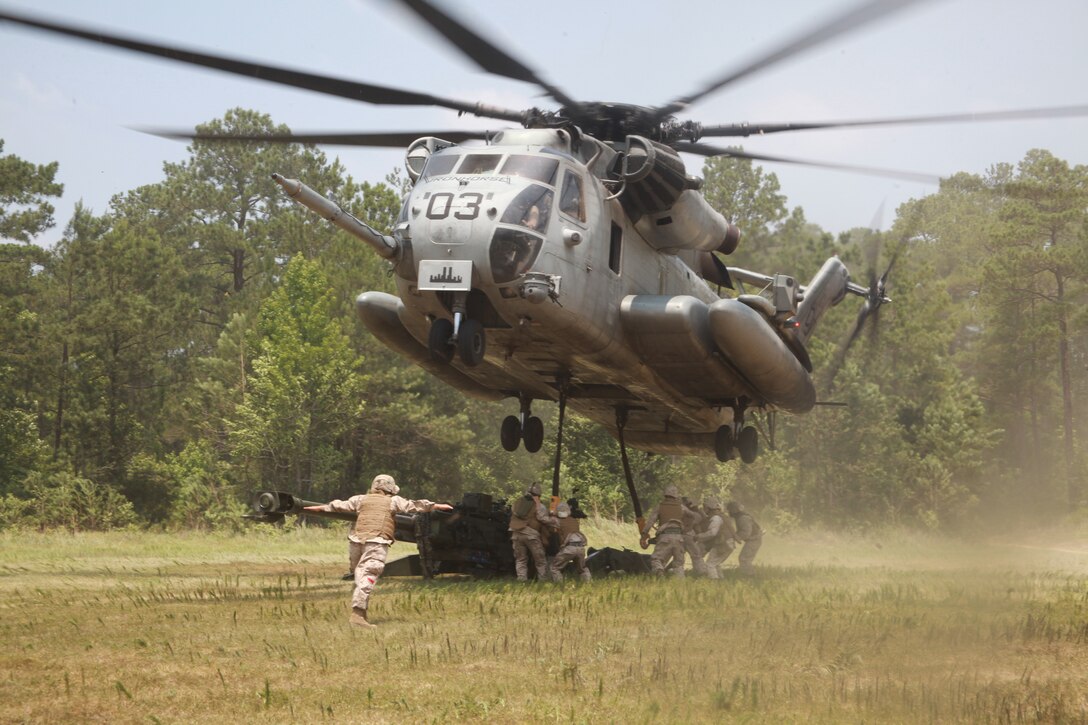 A CH-53E Super Stallion with Marine Heavy Helicopter Squadron 461 hovers over a M777 155 mm Howitzer while Marines from 3rd Battalion, 10th Marine Regiment, Lima Battery, attach it to the aircraft in support of Exercise Mailed Fist at a range outside of Marine Corps Base Camp Lejeune, N.C., June 21. The lift was in support of Exercise Mailed Fist, a large-scale exercise conducted by 2nd Marine Aircraft Wing.