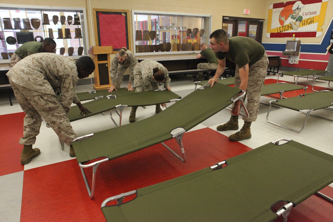 Marines with Companies A, B and I, Headquarters and Support Battalion, set up storm shelter preparation at Lejeune High School as part of the base destructive weather exercise hosted aboard Marine Corps Base Camp Lejeune July 18. In the event of a destructive weather situation, MCB Camp Lejeune will have shelters established at LHS, Brewster Middle School and Tarawa Terrace II Elementary School. 