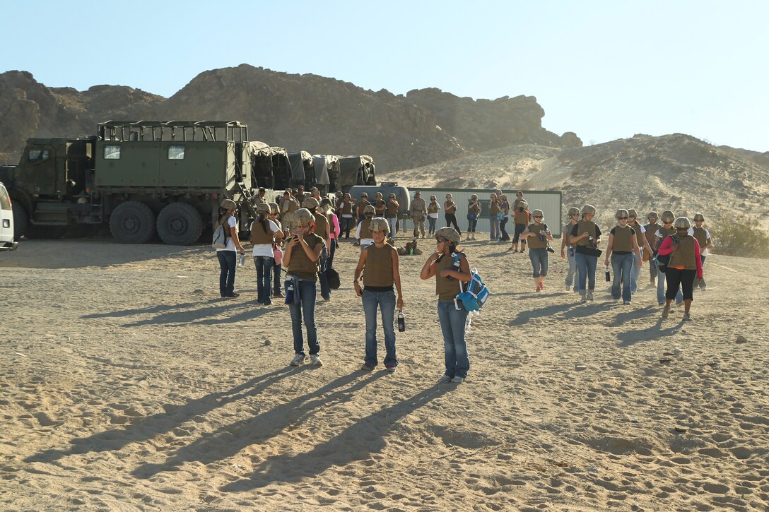 2nd Battalion, 7th Marine Regiment, spouses and family members gear up shortly before loading the 7-ton vehicles to travel to Range 101 during the 2/7 Jayne Wayne Day event June 29.